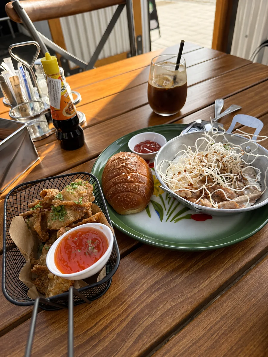 Brunch and iced coffee beside a sunlit window at 71st Cafe x Bar