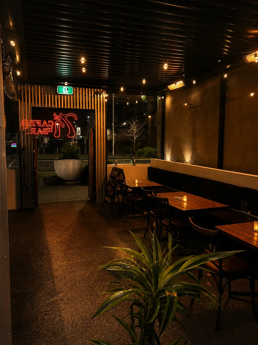 Warm lights and seating in the evening at 71st Cafe x Bar