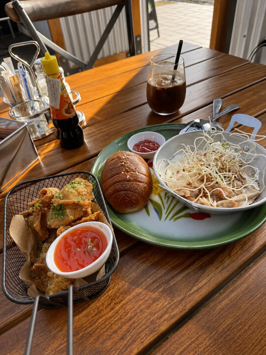 A table with brunch, iced coffee and fried bites